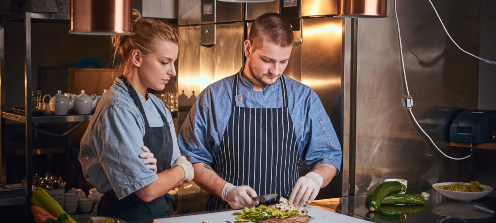 male chef with assistant standing in a kitchen pre PCVW5CR 1