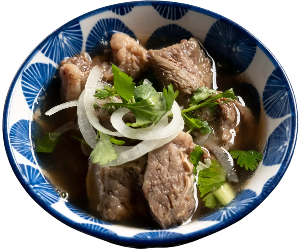 Rib Cubes side order at Pho REDBO in Garden Grove served in a broth-filled bowl with onions and fresh herbs.