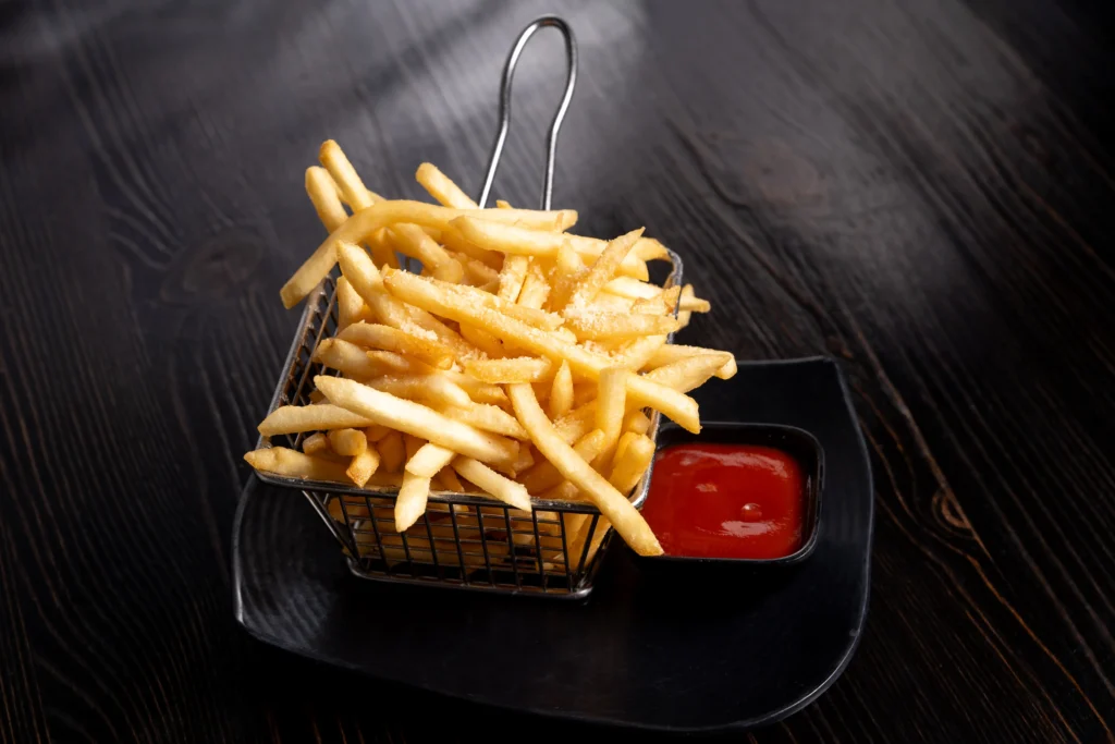 Golden Truffle Fries at Pho REDBO in Garden Grove served in a metal basket with ketchup on the side.